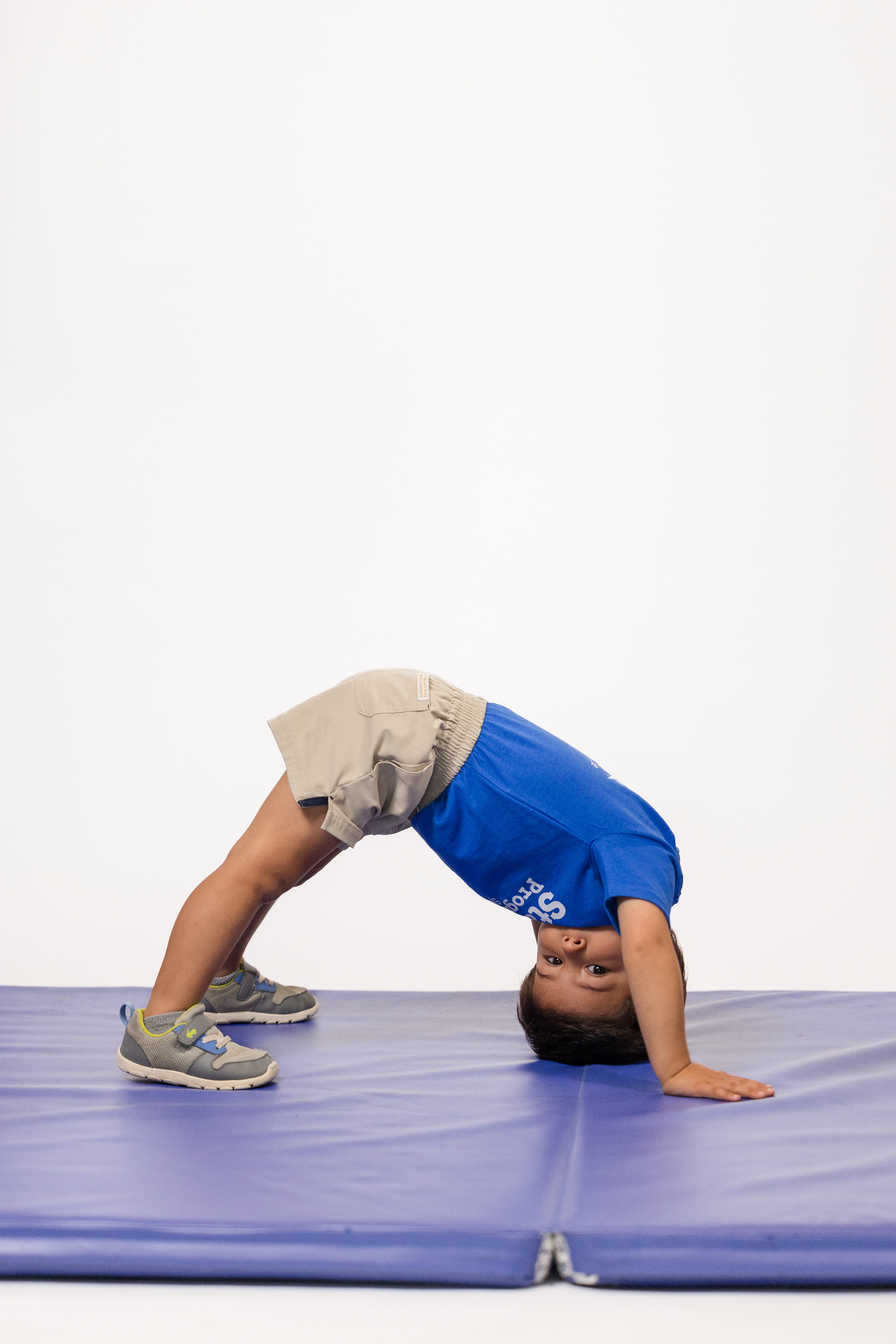 Child in a yoga bridge pose at Beats and Balance class